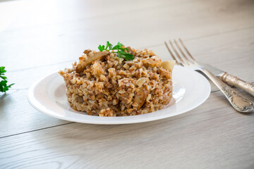 cooked buckwheat boiled with mushroom filling in a plate