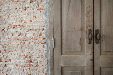 Contrasting Textures, Vintage Wooden Door Beside Weathered Brick Wall.