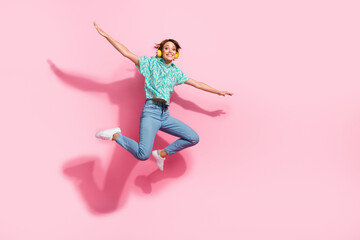 Fototapeta na wymiar Full body photo of overjoyed excited lady jump arms wings fly empty space ad isolated on pink color background