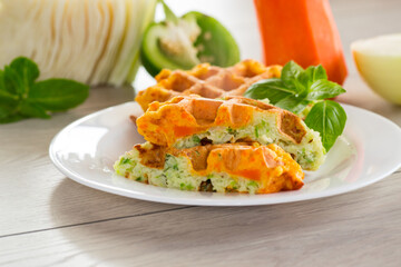cooked two-color vegetable waffles made from cabbage and carrots.