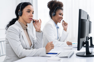 Business people wearing headset working in office to support remote customer or colleague. Call center, telemarketing, customer support agent provide service on telephone video conference call crucial