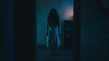Possessed witch with long hair standing in haunted house room, evil spirit