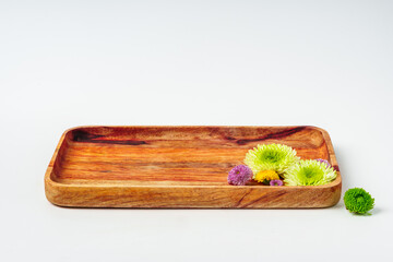 Wooden tray with flowers isolated on white background