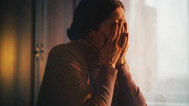 Depressed senior woman crying after receiving bad news, expensive bills, poverty
