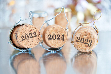new year decorations on shining background with copy space, chocolate coins and champagne cork 2024, Christmas background, Wealth and health new year.