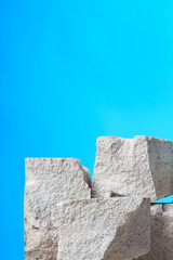 Pieces of granite stone against blue background