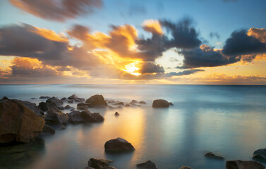 Fototapeta na wymiar Beautiful sunset over the ocean and rock.