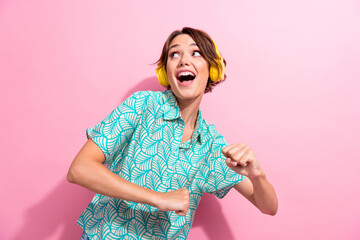 Photo of pretty cheerful girl enjoy new playlist headphones dancing chilling isolated on pink color...