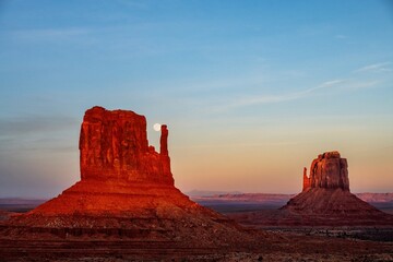 Moon rises between the thumb and mitten