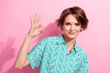 Portrait of gorgeous business lady showing fingers okey symbol approving wear printed summer shirt...