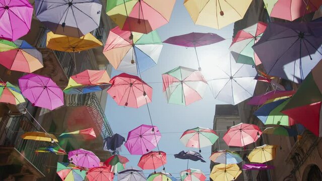 Historic Street of Catania adorned with colorful Umbrellas 