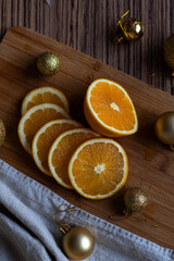 New Year's layout of oranges, board, napkins, garlands and balloons on the kitchen table.Preparations for the holiday.Preparing for the celebration of Christmas.The concept of a cozy kitchen