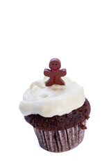 brown cupcake with white frosting and gingerbread figure decoration isolated on white