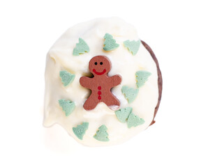 cupcake with white frosting, green christmastree sprinkles, gingerbread figure from above isolated on white