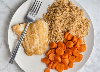 baked cod  with a side of carrots  and brown rice