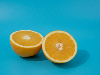 Ripe oranges on a blue background. Oranges on blue.
