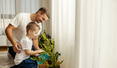 Father is teaching his son about chores and how to take care of houseplants. - obrazy, fototapety, plakaty