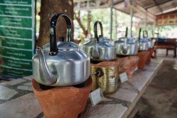 Row of Metal Tea Kettles Ready for Service.