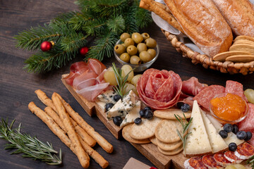 Charcuterie board italian food antipasti prosciutto ham, salami and cheese appetizers served in the shape of a Christmas tree.  party food for New Year's Eve and Christmas