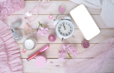 coffee cup, smartphone with blank screen, cosmetics, perfume in spray bottle, donut, sakura flowers, good morning concept, coffee time in boudoir, female life