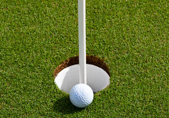 Golf ball on a green near the hole