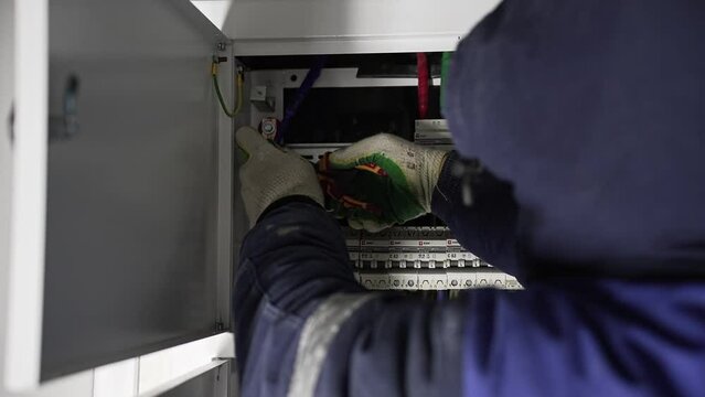 worker at a construction site assembles an Electrical panel