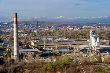 industrial area from above, factory with mountains in the background 