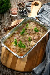 Jelly with shredded chicken meat in a mold.