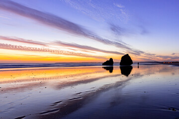Twilight Tapestry: Praia dos Tres Irmaos Beach, Alvor, Portugal, where Vibrant Sunset Colors Paint...
