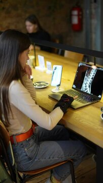 A medical university student studying online with a laptop at a cafe.