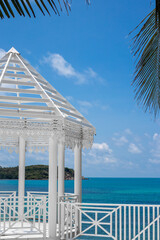 White carved gazebo on the seashore in a tropical country. Holidays in Asia