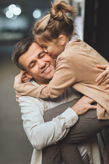 Dad and teenage daughter having fun on a walk in the city. 