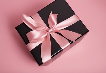 Gift present box with satin bow on light pink background top view