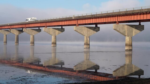 bridge over Tennessee River from Tennessee to Alabama with traffic, foggy November sunrise - Natchez Trace National Parkway 