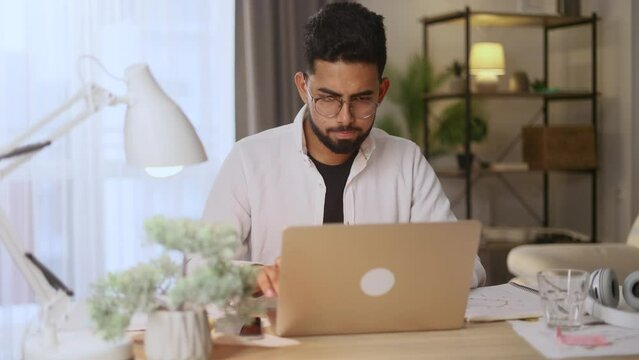 Sad young man feels annoyed having problems with laptop computer lost work at home System error data loss backup battery issues virus old equipment or technical malfunctions indoors