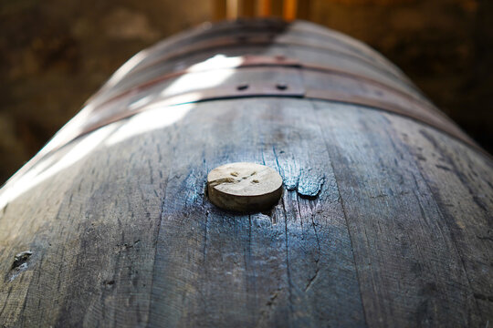 Close-up of a bung in a whisky cask. The bung closes the bung hole in the barrel to seal it.