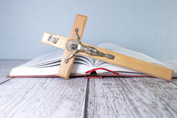 Closeup of simple wooden Christian cross necklace on Bible , vintage tone , god