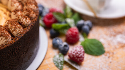 close-up of cheesecake with cream filling, decorated with fresh berries, blueberries and raspberries, festive New Year's cake, Christmas	