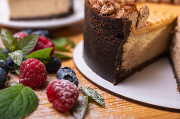 close-up of cheesecake with cream filling, decorated with fresh berries, blueberries and raspberries, festive New Year's cake, Christmas	
