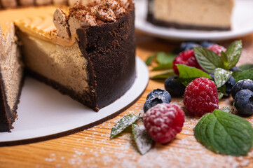 close-up of cheesecake with cream filling, decorated with fresh berries, blueberries and raspberries, festive New Year's cake, Christmas	