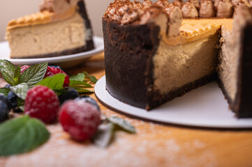 close-up of cheesecake with cream filling, decorated with fresh berries, blueberries and raspberries, festive New Year's cake, Christmas