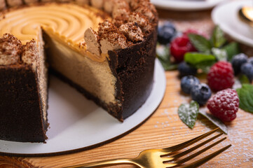 close-up of cheesecake with cream filling, decorated with fresh berries, blueberries and raspberries, festive New Year's cake, Christmas	
