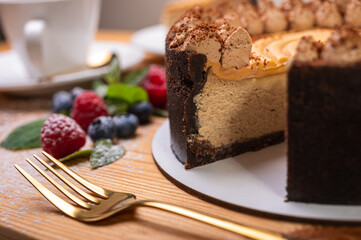 close-up of cheesecake with cream filling, decorated with fresh berries, blueberries and raspberries, festive New Year's cake, Christmas