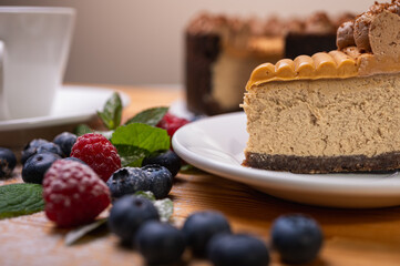 close-up of cheesecake with cream filling, decorated with fresh berries, blueberries and raspberries, festive New Year's cake, Christmas