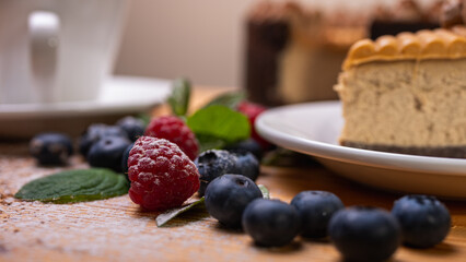 close-up of cheesecake with cream filling, decorated with fresh berries, blueberries and raspberries, festive New Year's cake, Christmas