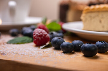 close-up of cheesecake with cream filling, decorated with fresh berries, blueberries and raspberries, festive New Year's cake, Christmas	