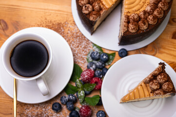 close-up of cheesecake with cream filling, decorated with fresh berries, blueberries and raspberries, festive New Year's cake, Christmas. From above