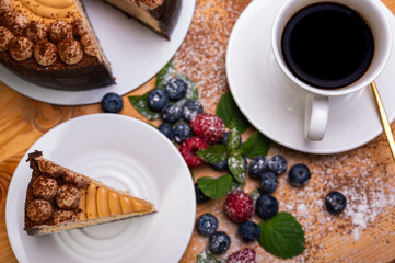 close-up of cheesecake with cream filling, decorated with fresh berries, blueberries and raspberries, festive New Year's cake, Christmas	