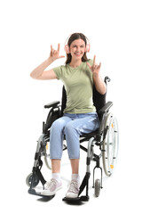 Fototapeta na wymiar Young woman in wheelchair with headphones showing 