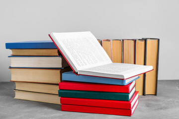 Open and closed books on grey grunge table